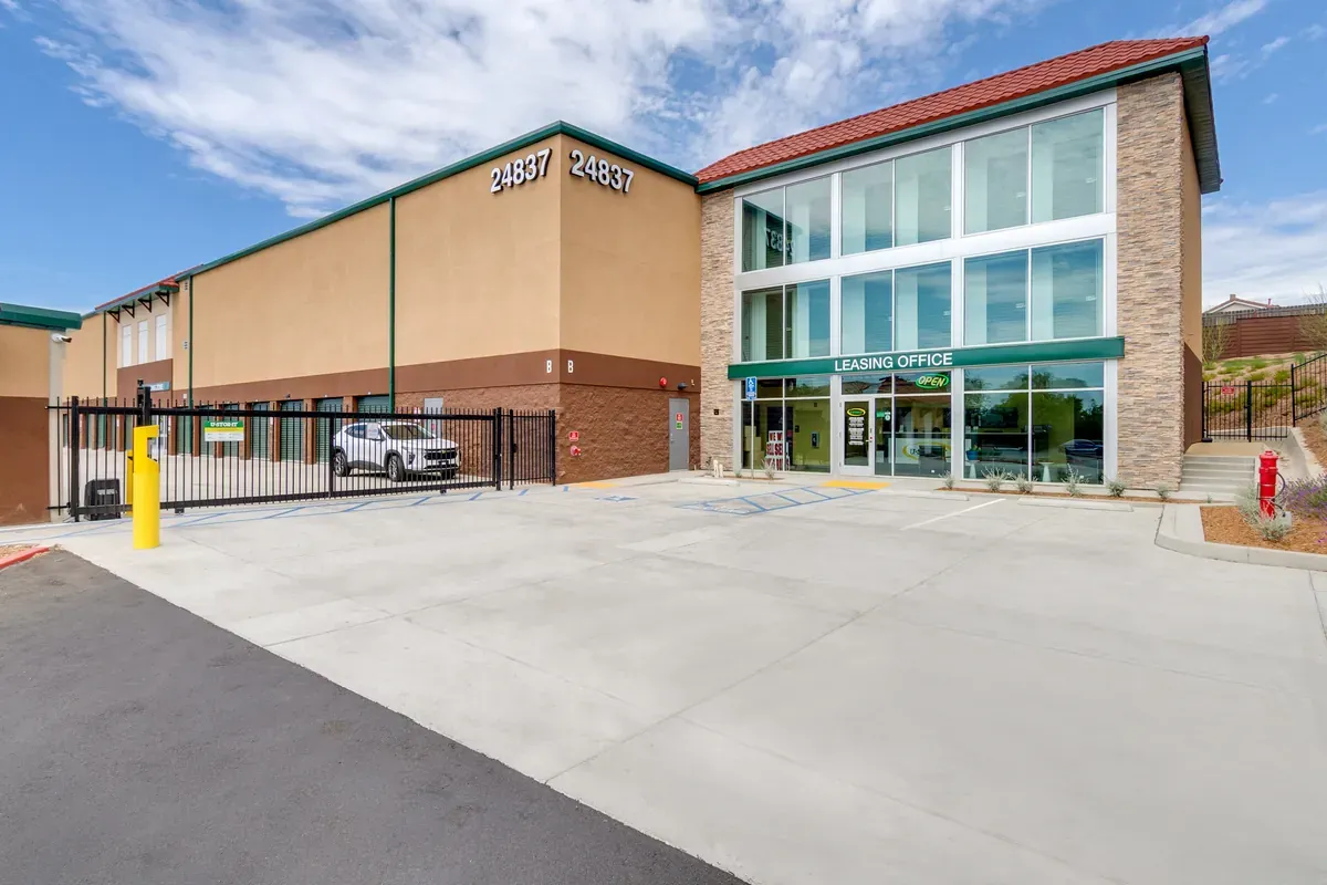 Exterior view of a modern U-Stor-It self-storage facility exterior featuring a glass rental office entry.